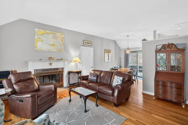 a living room with furniture a window and a fireplace