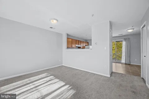 a view of a livingroom with wooden floor and a window