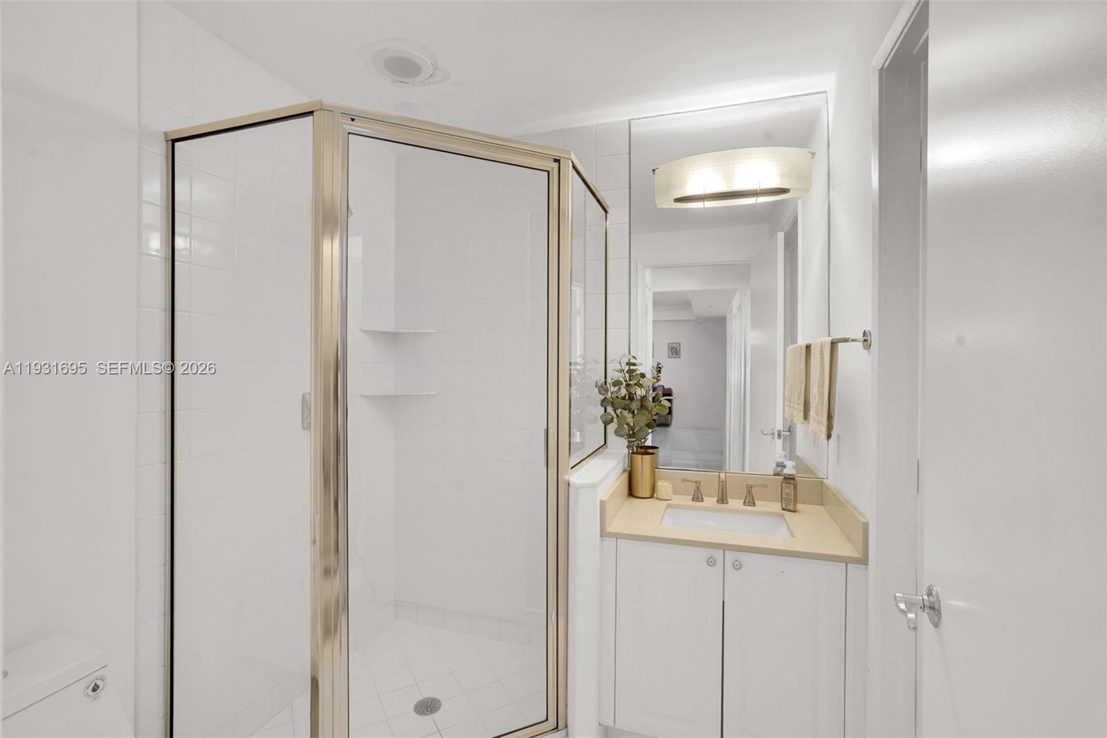 735 Crandon Boulevard, Unit 503 Key Biscayne, FL 33149 - Photo 12 of 38 a bathroom with a glass shower door and a sink