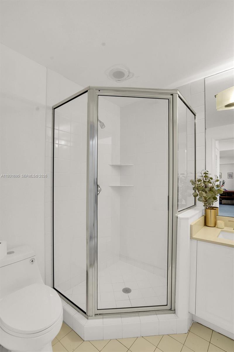 735 Crandon Boulevard, Unit 503 Key Biscayne, FL 33149 - Photo 13 of 38 a bathroom with a shower a toilet and sink