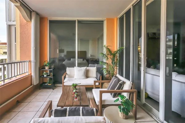 a living room filled with furniture and a potted plant