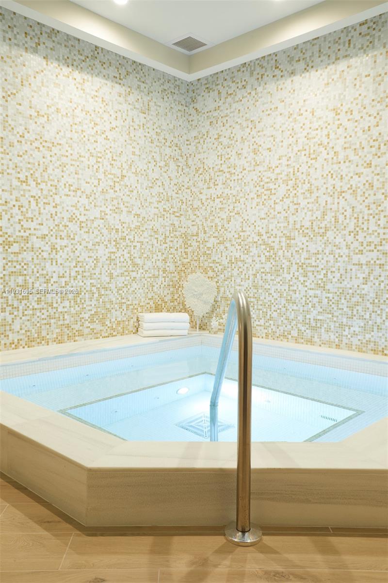 735 Crandon Boulevard, Unit 503 Key Biscayne, FL 33149 - Photo 33 of 38 a bathroom with a bathtub