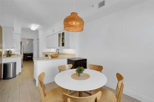 a kitchen with a dining table and chairs