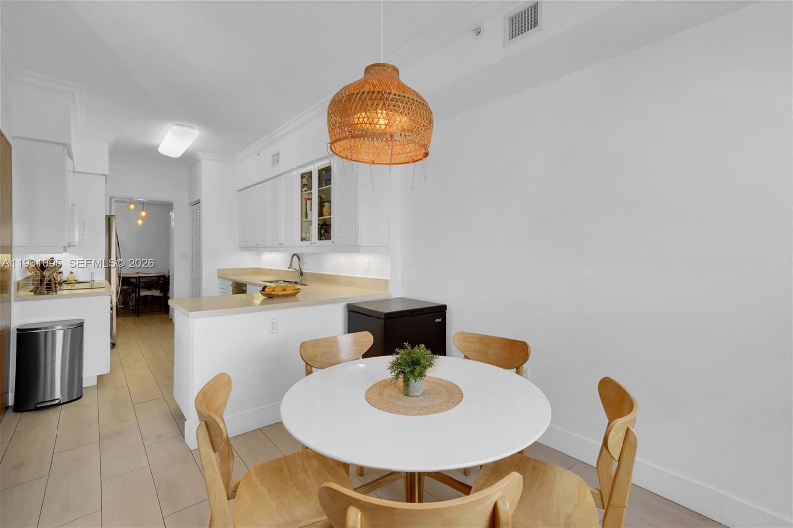 735 Crandon Boulevard, Unit 503 Key Biscayne, FL 33149 - Photo 8 of 38 a kitchen with a dining table and chairs