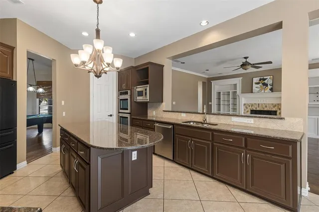 a kitchen with stainless steel appliances granite countertop a sink and dishwasher