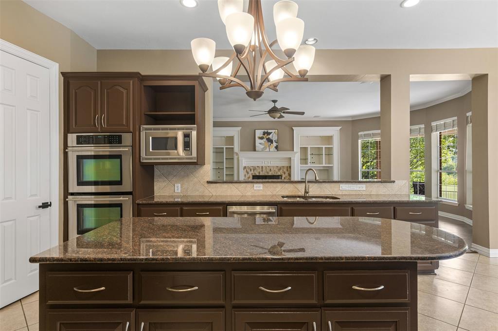 2070 Azalea Trail Irving, TX 75063 - Photo 13 of 36 a view of a kitchen with a sink and chandelier