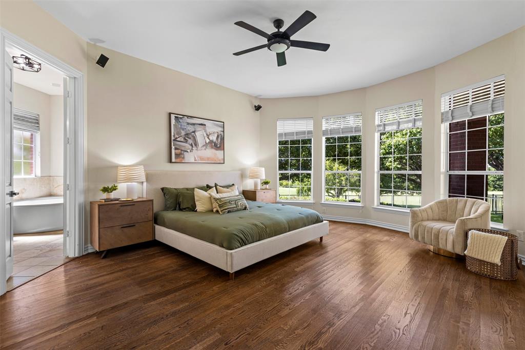 2070 Azalea Trail Irving, TX 75063 - Photo 15 of 36 a spacious bedroom with a bed couch and a large window