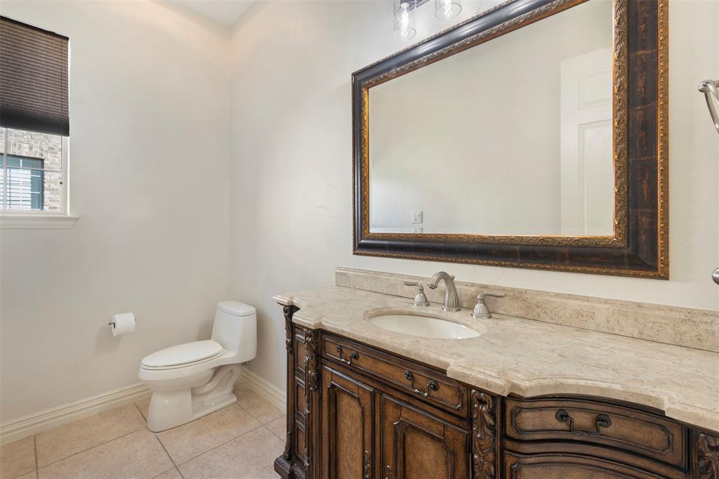 2070 Azalea Trail Irving, TX 75063 - Photo 19 of 36 a bathroom with a granite countertop sink a toilet and a mirror