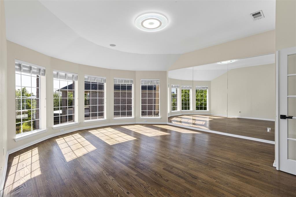 2070 Azalea Trail Irving, TX 75063 - Photo 20 of 36 a view of an empty room with wooden floor and a window