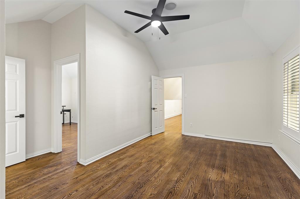 2070 Azalea Trail Irving, TX 75063 - Photo 21 of 36 an empty room with wooden floor cabinet and windows