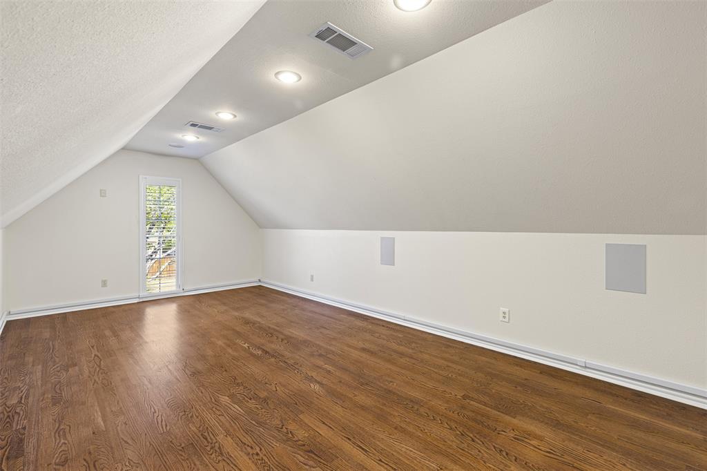2070 Azalea Trail Irving, TX 75063 - Photo 22 of 36 an empty room with wooden floor and windows