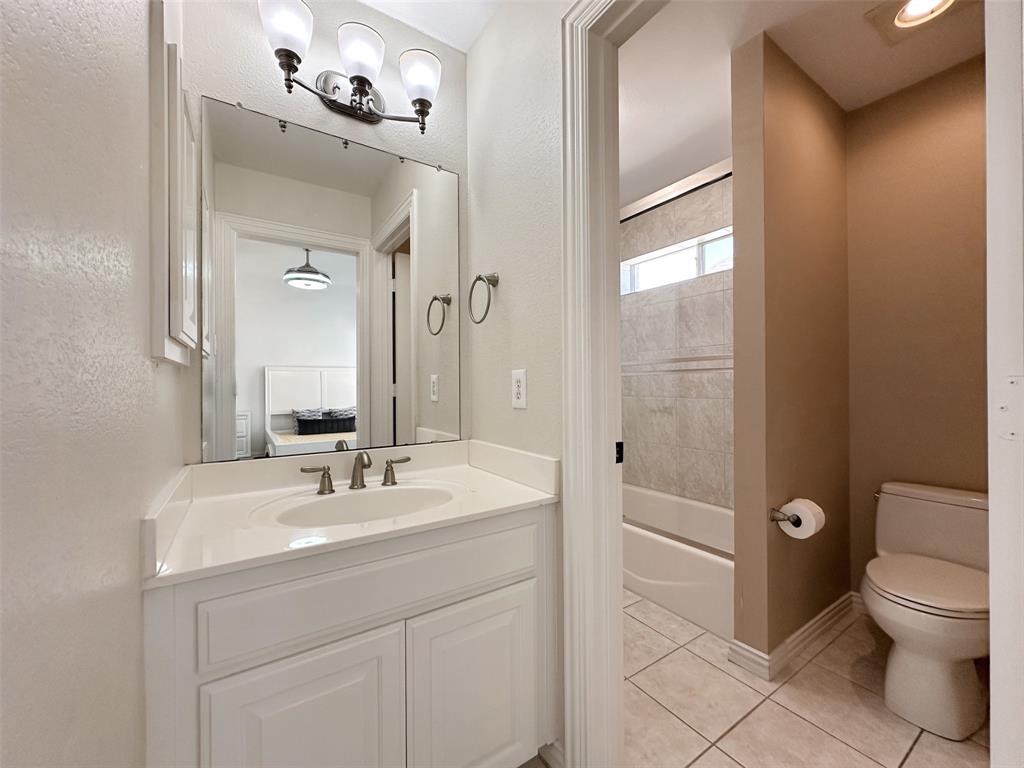 2070 Azalea Trail Irving, TX 75063 - Photo 26 of 36 a bathroom with a sink a toilet and a mirror