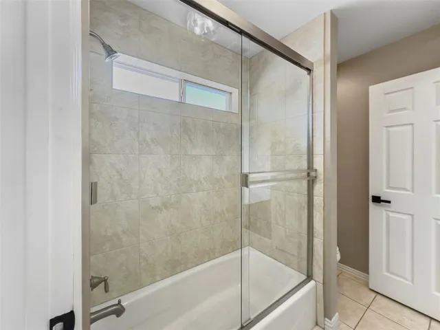 a bathroom with a glass shower door
