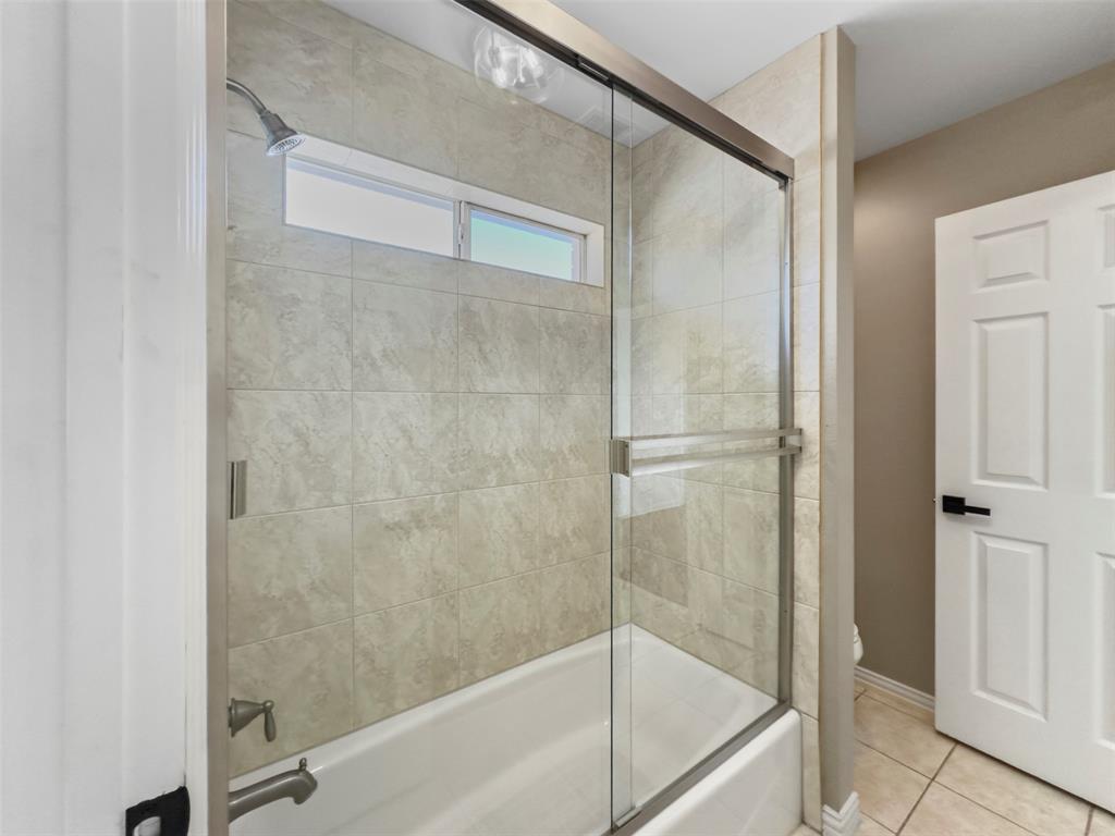 2070 Azalea Trail Irving, TX 75063 - Photo 27 of 36 a bathroom with a glass shower door