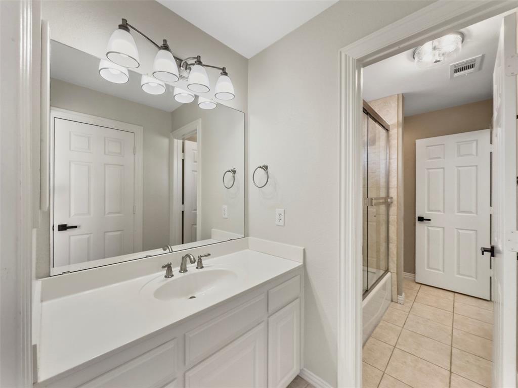 2070 Azalea Trail Irving, TX 75063 - Photo 28 of 36 a bathroom with a sink a light fixture and a mirror
