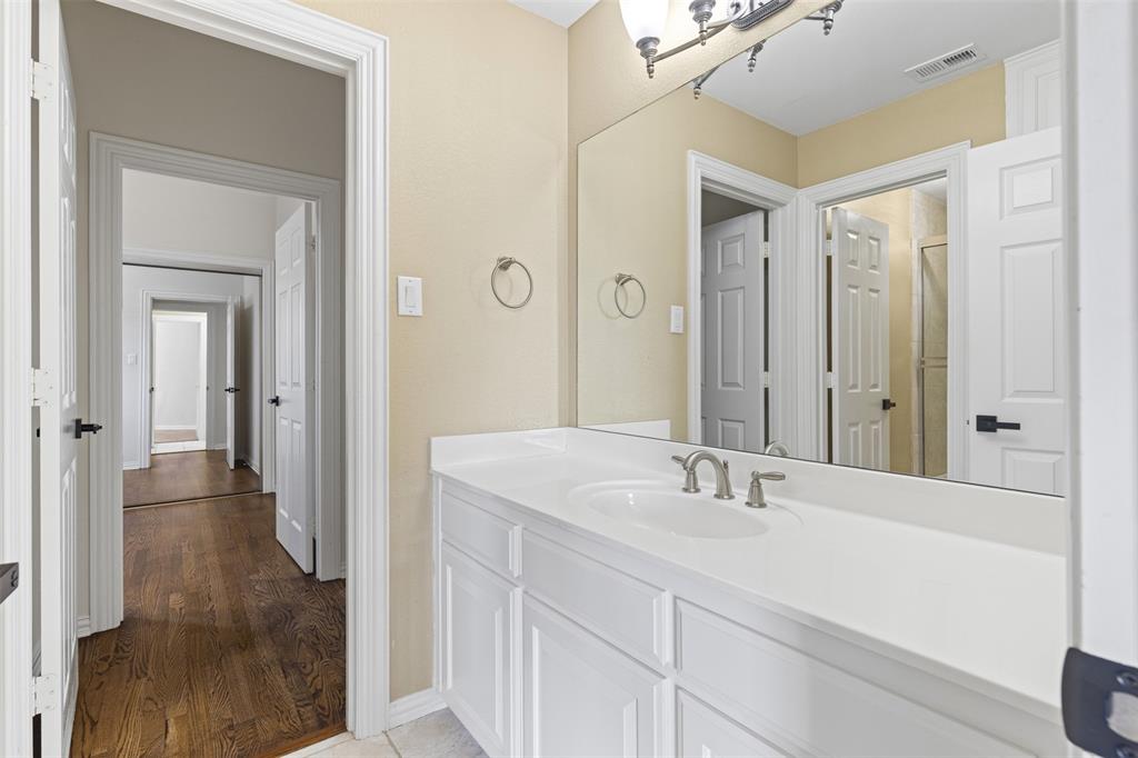 2070 Azalea Trail Irving, TX 75063 - Photo 31 of 36 a bathroom with a sink and a mirror