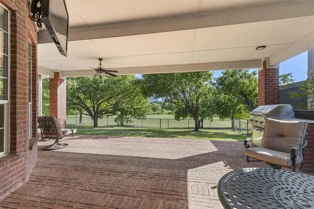 a view of a porch with furniture and a yard
