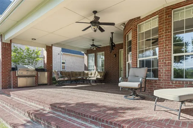 a building outdoor space with patio furniture and potted plants