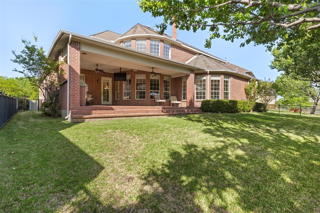 2070 Azalea Trail Irving, TX 75063 - Photo 34 of 36 a front view of a house with a yard table and chairs