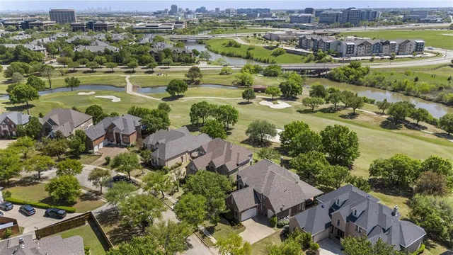 an aerial view of residential houses with outdoor space and river