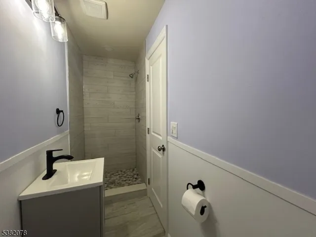a bathroom with a shower and mirror