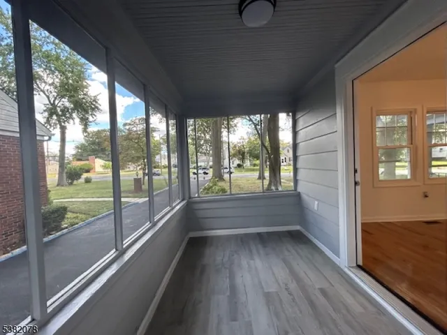 a view of room with window and wooden floor