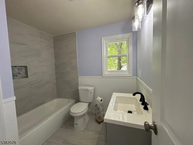 a bathroom with a sink a toilet and bathtub