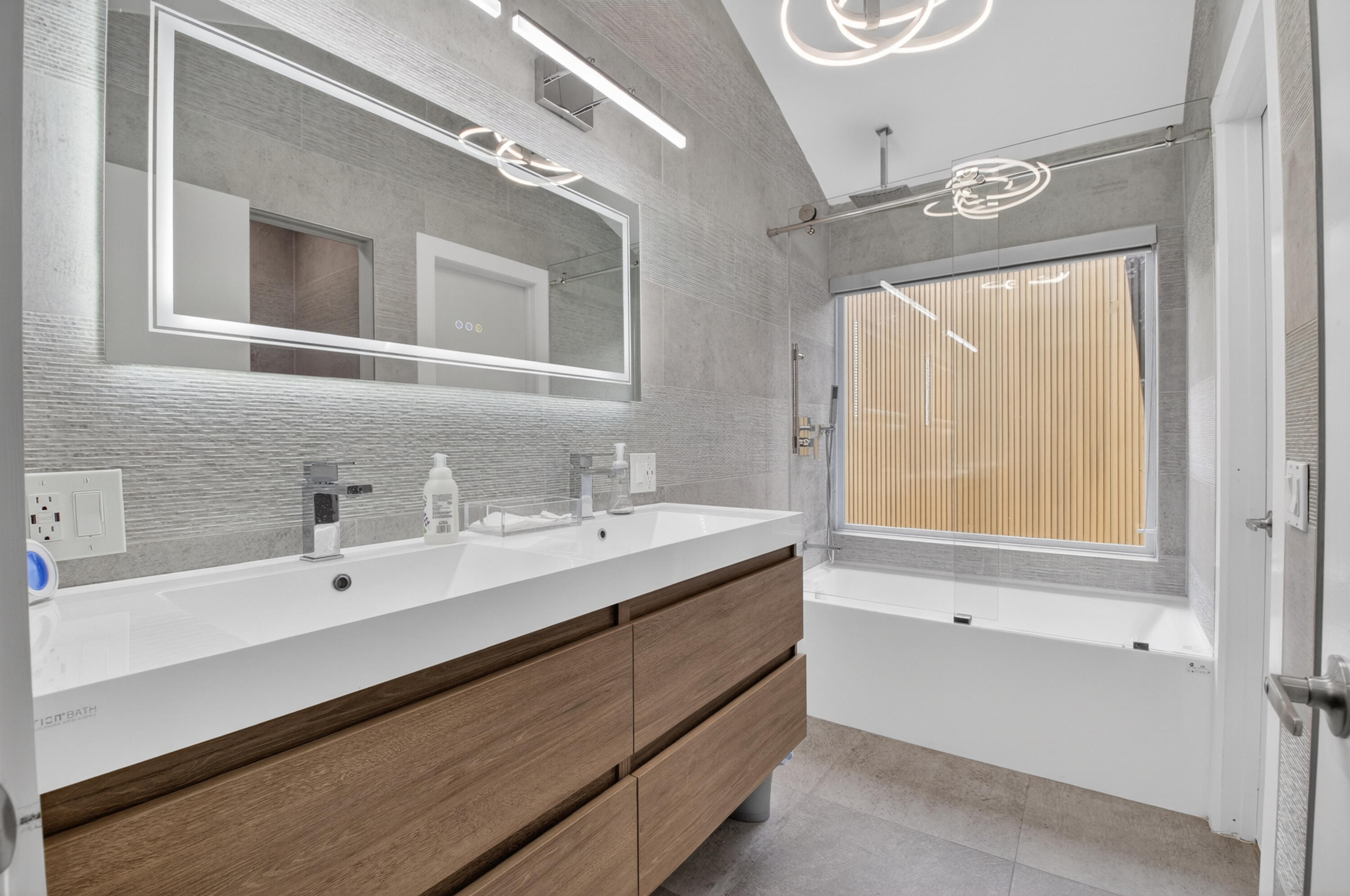7374 Woodmont Court Boca Raton, FL 33434 - Photo 34 of 95 a bathroom with a double vanity sink mirror and a bathtub