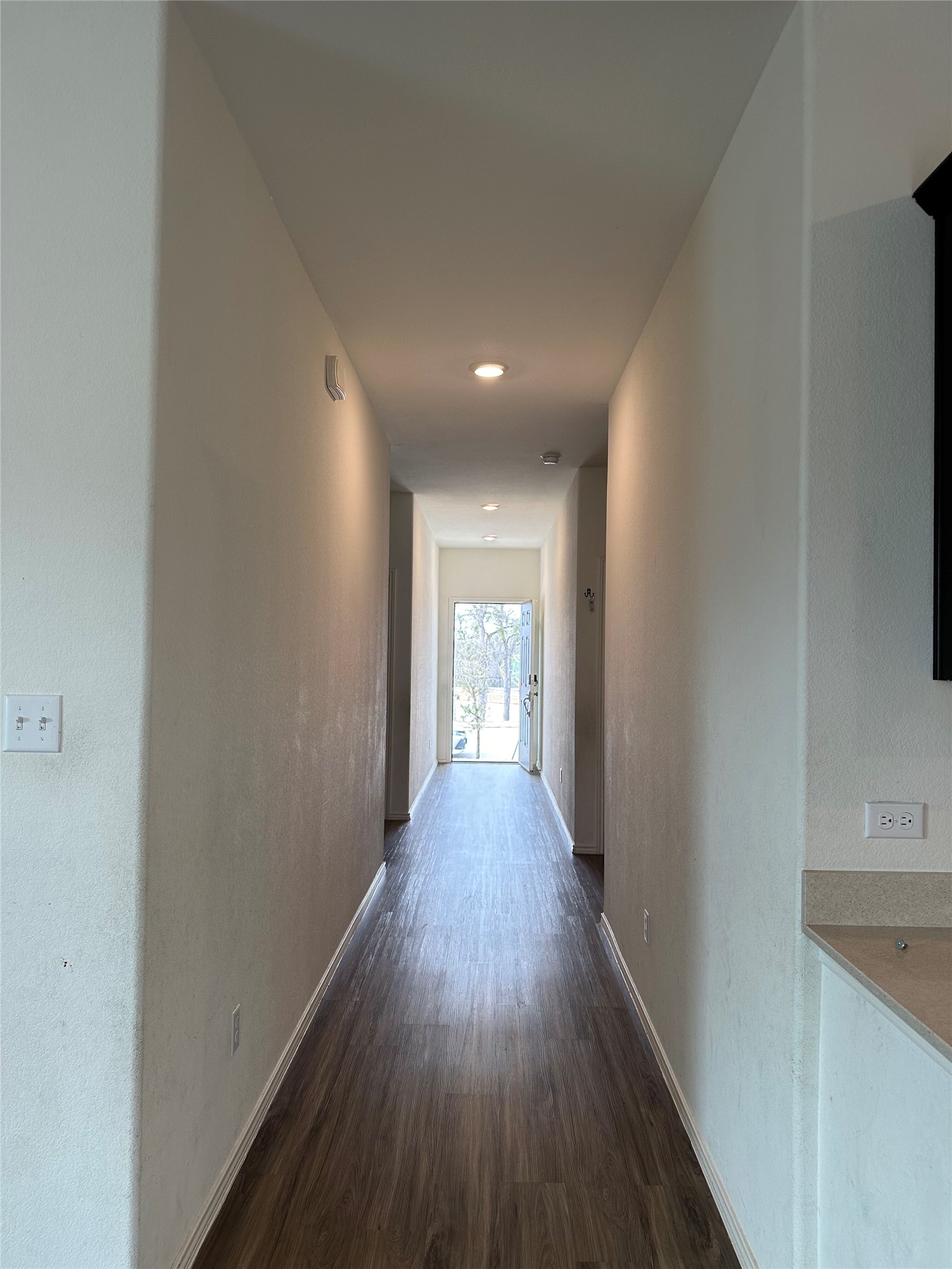 13501 Mussel Run Elgin, TX 78621 - Photo 13 of 28 Hallway featuring wood-finish flooring, recessed lighting, and a neutral color palette
