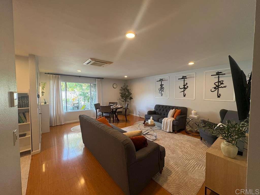 440 L Street, Unit J Chula Vista, CA 91911 - Photo 2 of 10 a living room with furniture a window and a flat screen tv