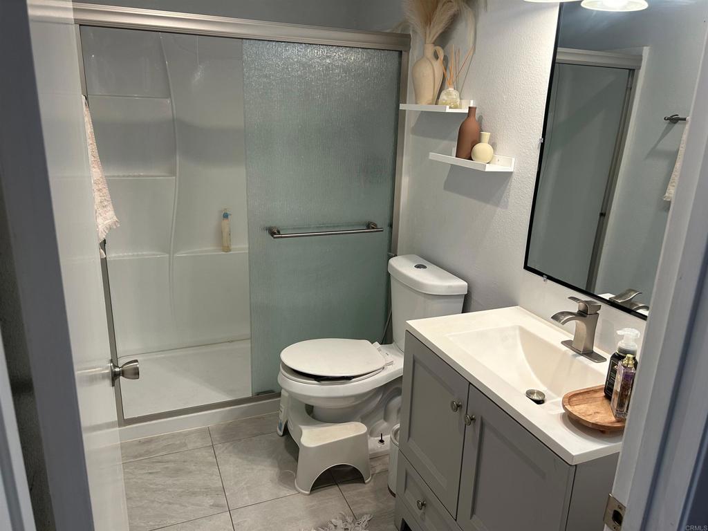 440 L Street, Unit J Chula Vista, CA 91911 - Photo 6 of 10 a bathroom with a sink toilet and shower
