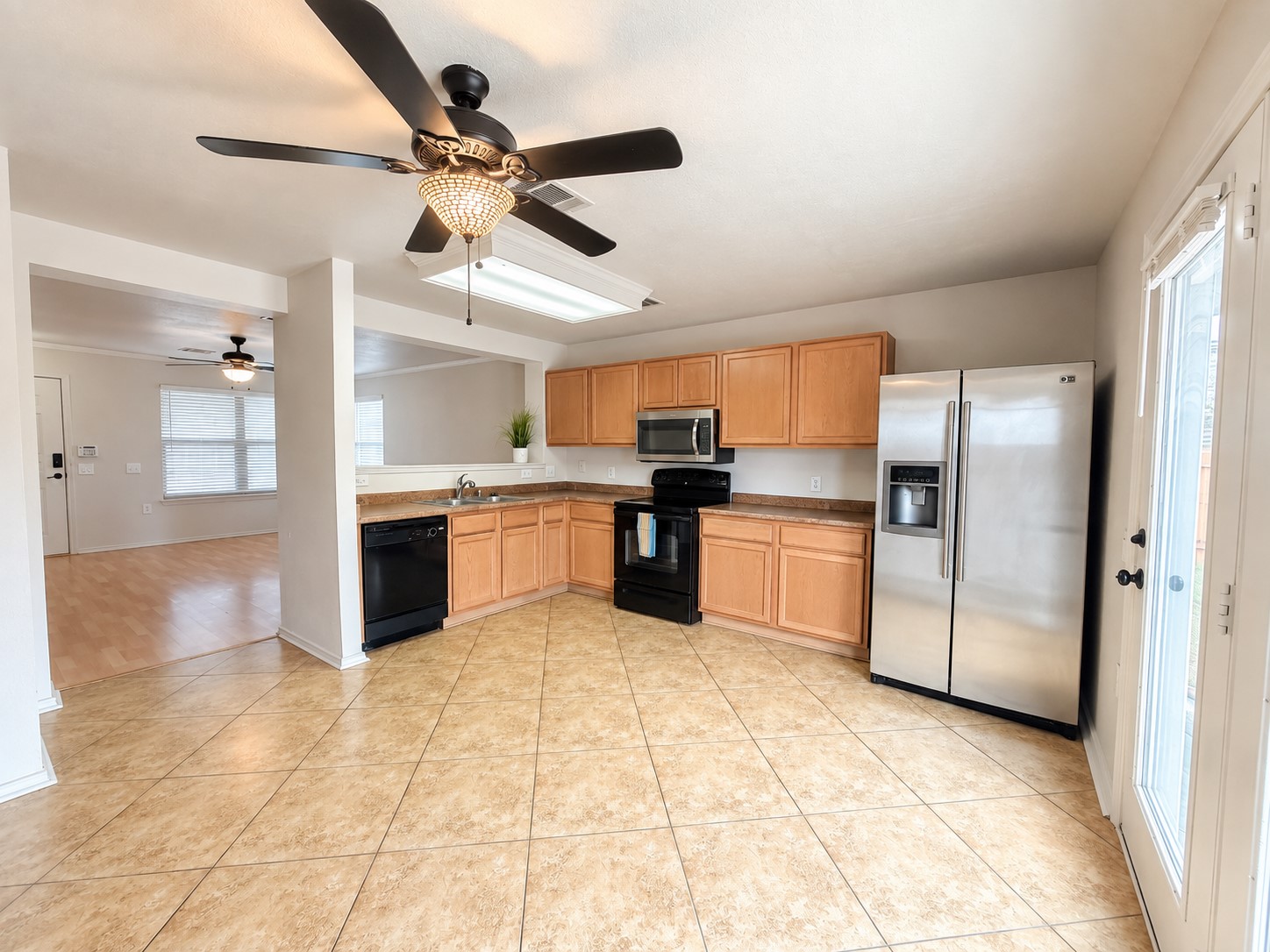 4601 Nuckols Crossing Road Austin, TX 78744 - Photo 4 of 18 An open kitchen layout flows seamlessly into the adjacent living space over durable tile flooring.