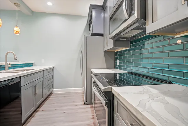 a kitchen that has a sink and a stove