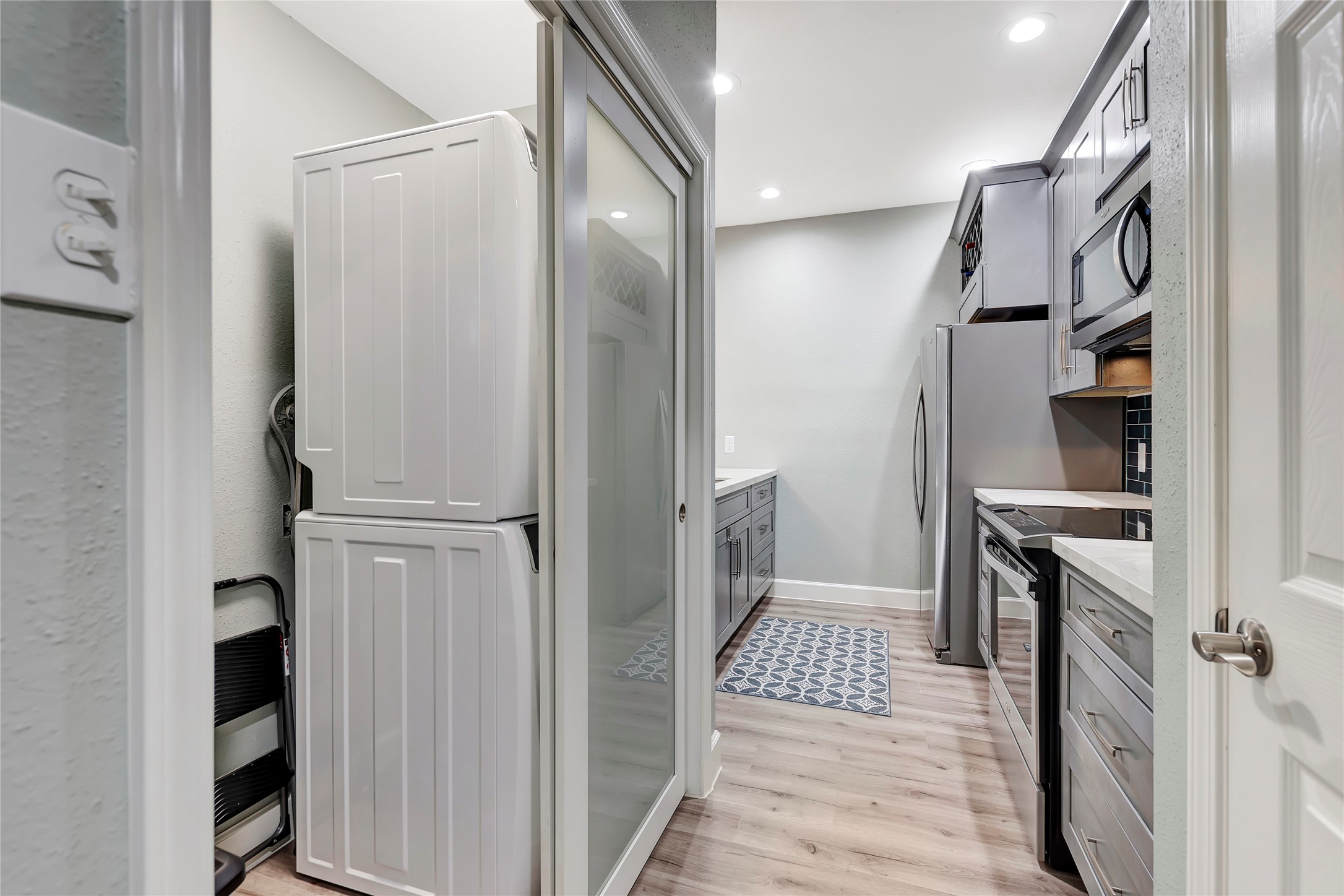 18809 Egret Bay Boulevard, Unit 112 Webster, TX 77058 - Photo 15 of 48 The kitchen also features a utility room with ample space for either a side-by-side or stackable washer. Stage Photo.