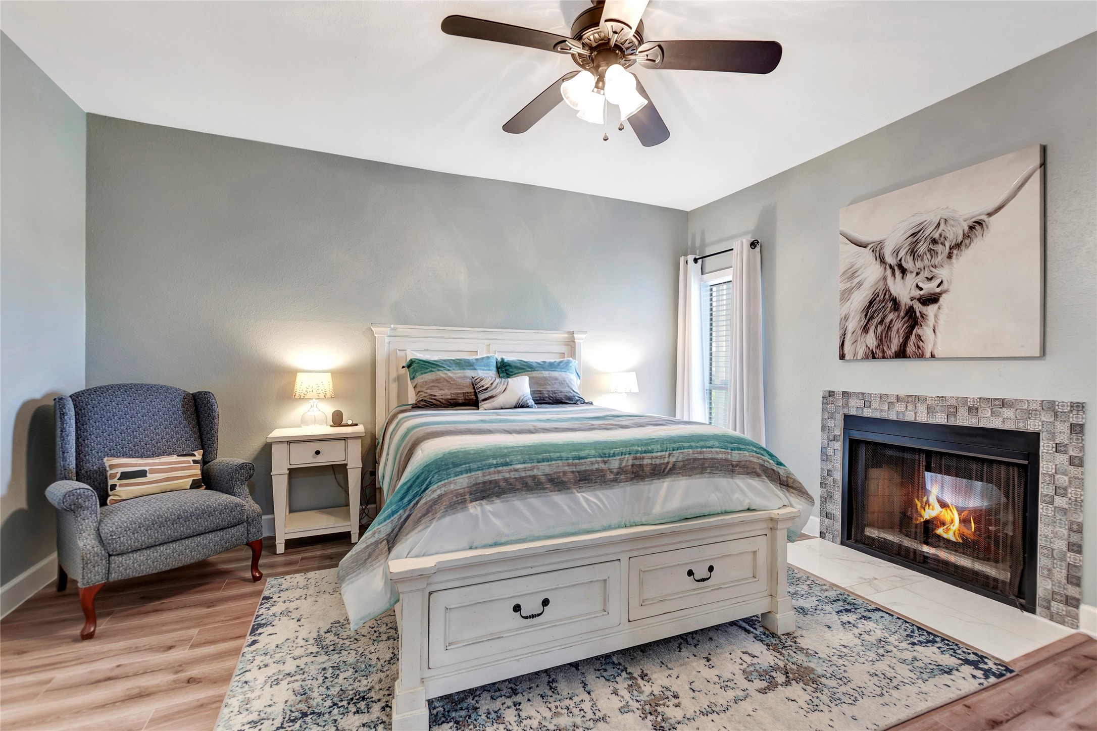 18809 Egret Bay Boulevard, Unit 112 Webster, TX 77058 - Photo 21 of 48 a bedroom with a bed and wooden floor