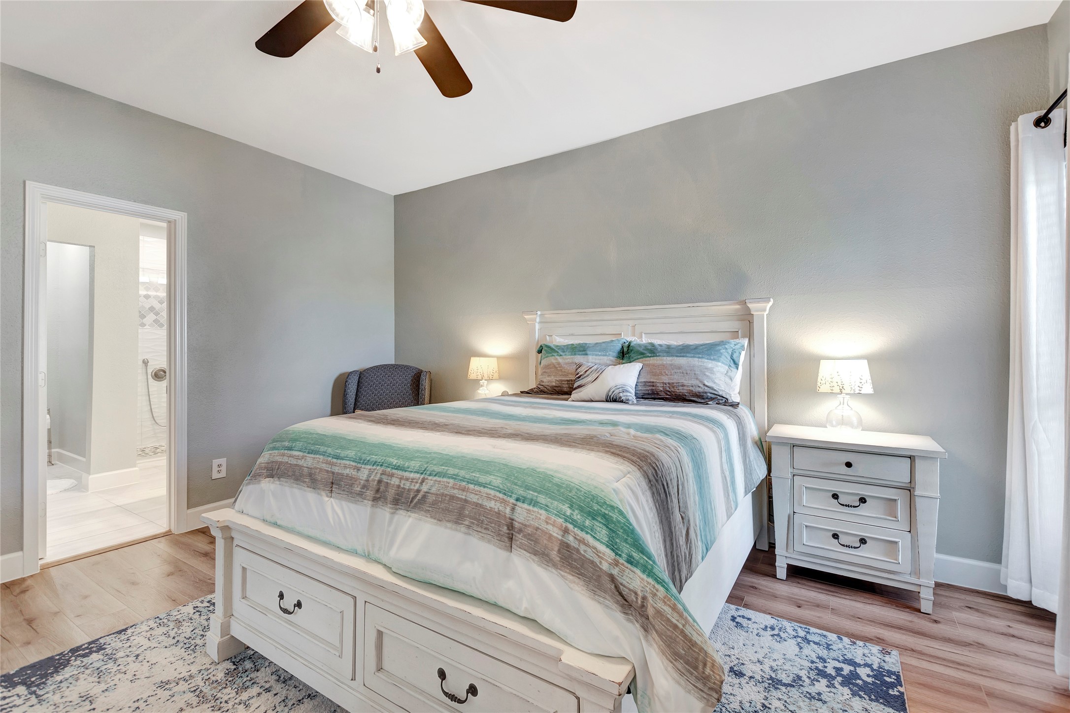 18809 Egret Bay Boulevard, Unit 112 Webster, TX 77058 - Photo 22 of 48 a bedroom with a bed and wooden floor