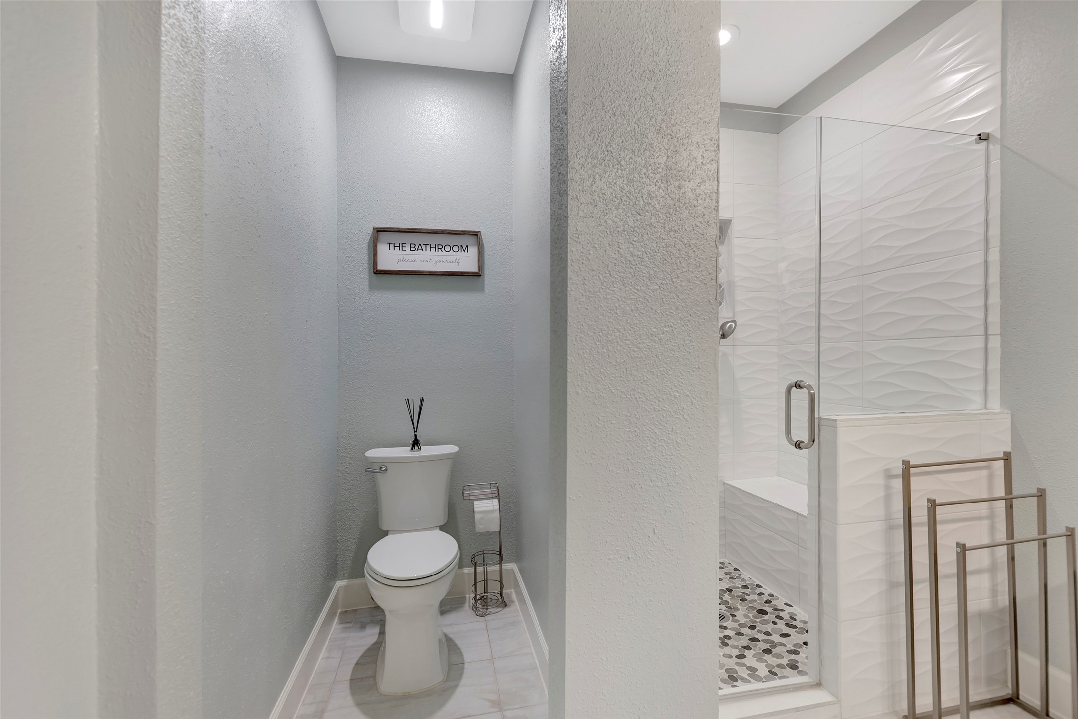 18809 Egret Bay Boulevard, Unit 112 Webster, TX 77058 - Photo 24 of 48 a white toilet sitting next to a bathroom sink