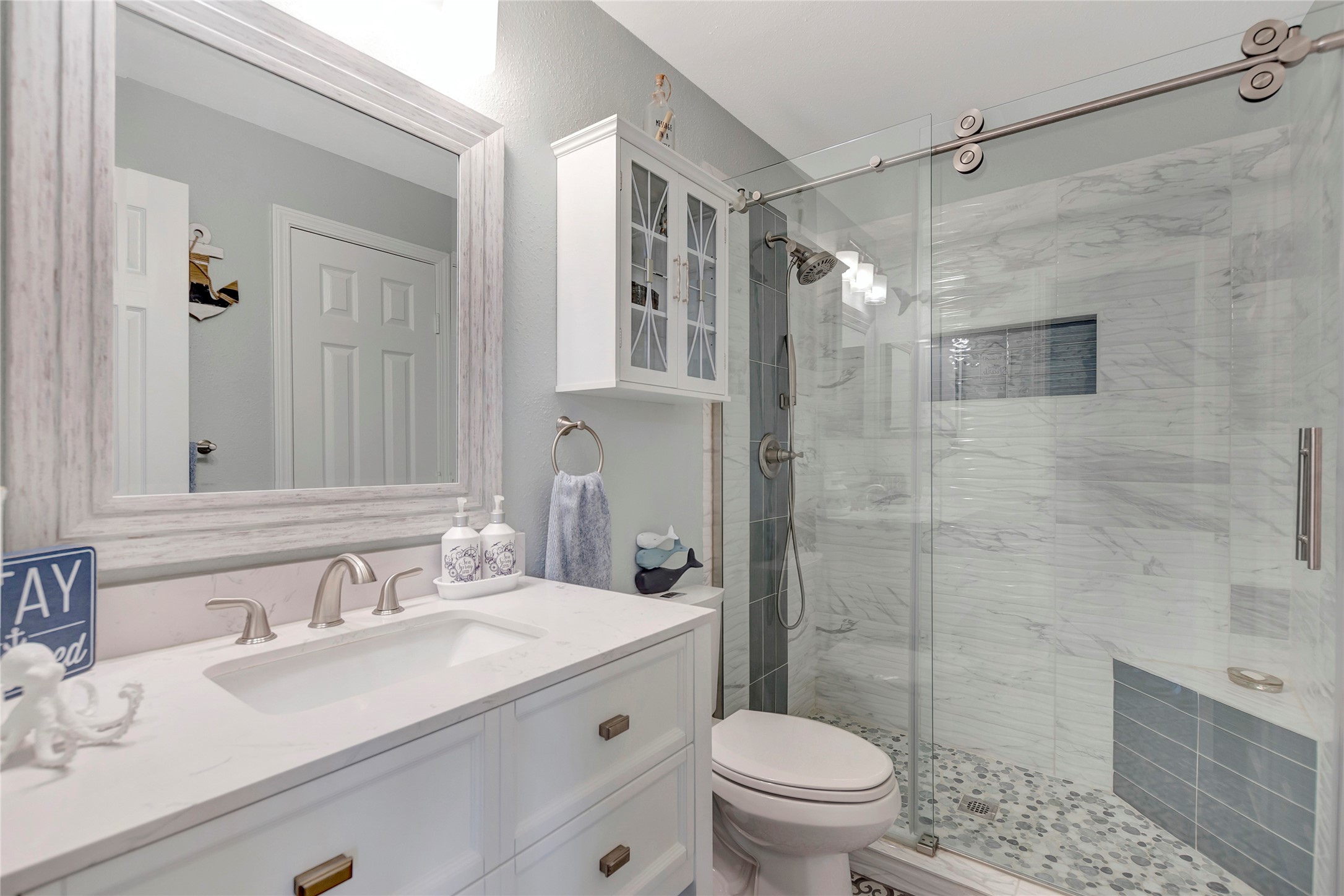 18809 Egret Bay Boulevard, Unit 112 Webster, TX 77058 - Photo 33 of 48 a bathroom with a sink toilet a mirror and shower