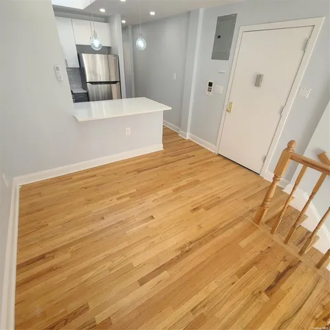a view of a room with wooden floor and staircase