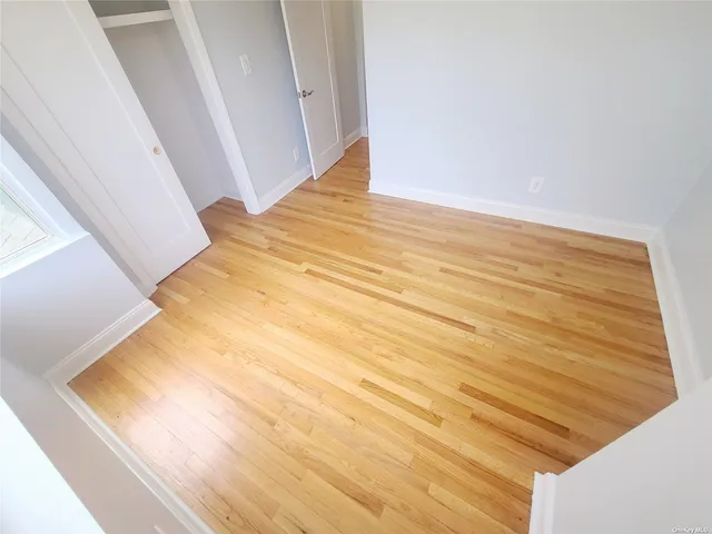 a view of a room with wooden floor