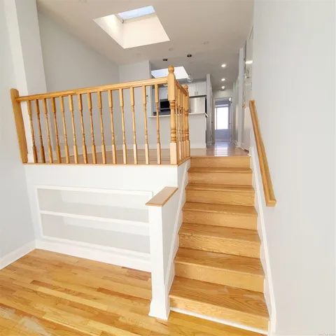 a view of entryway and hall with wooden floor