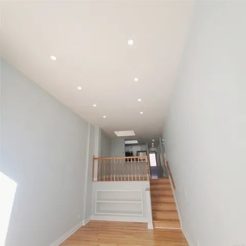 a view of entryway and hall with wooden floor