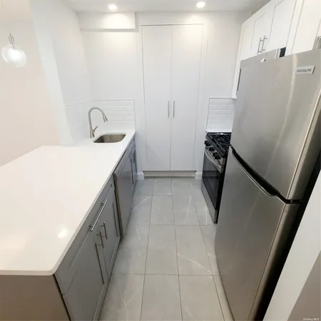 a utility room with cabinets washer and dryer