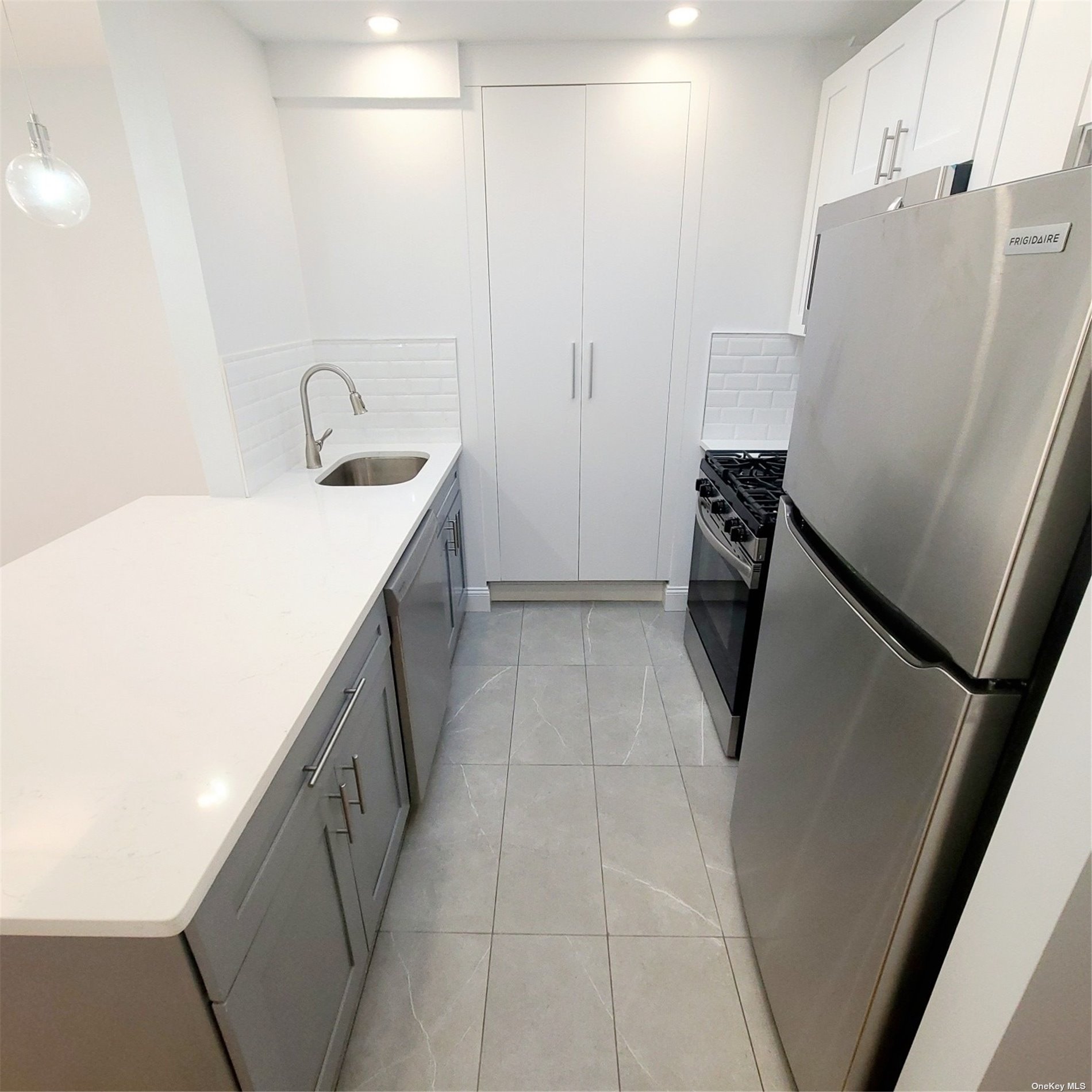 67-39 Clyde Street, Unit G Queens, NY 11375 - Photo 7 of 23 a utility room with cabinets washer and dryer