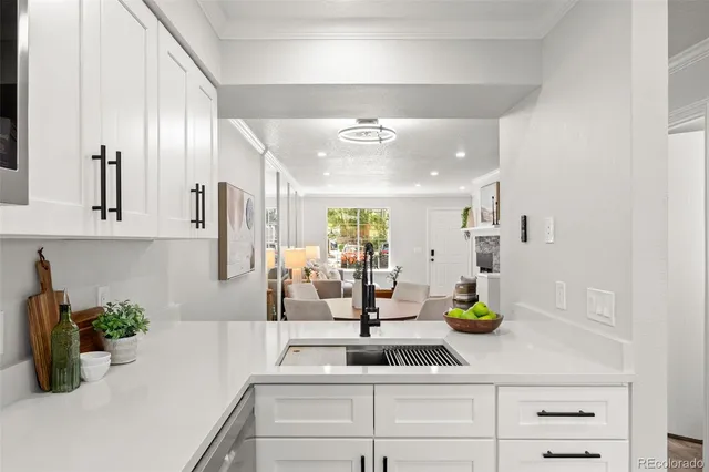 a kitchen with a faucet a stove and cabinets