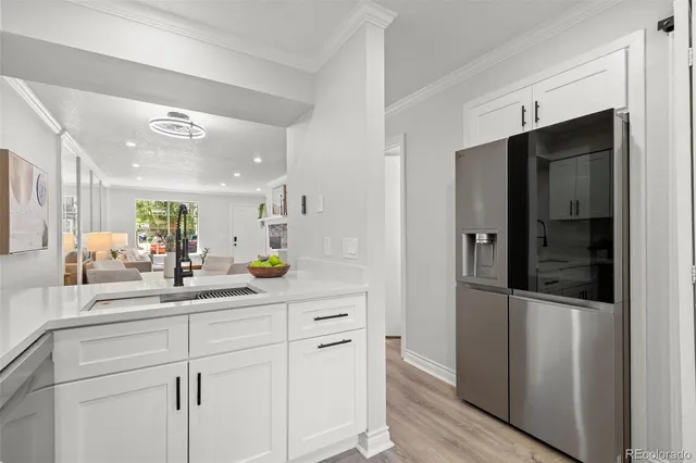 a kitchen with stainless steel appliances a refrigerator and a sink