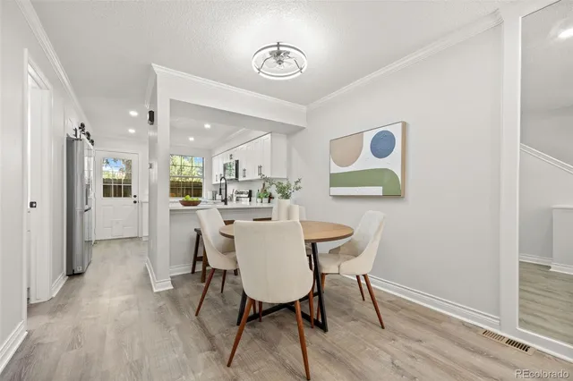 a view of a dining room with furniture and wooden floor