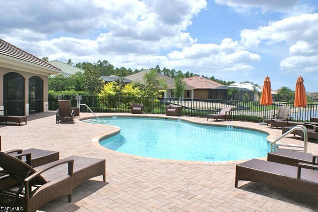 7414 Acorn Way Naples, FL 34119 - Photo 15 of 24 a view of a swimming pool with lounge chairs