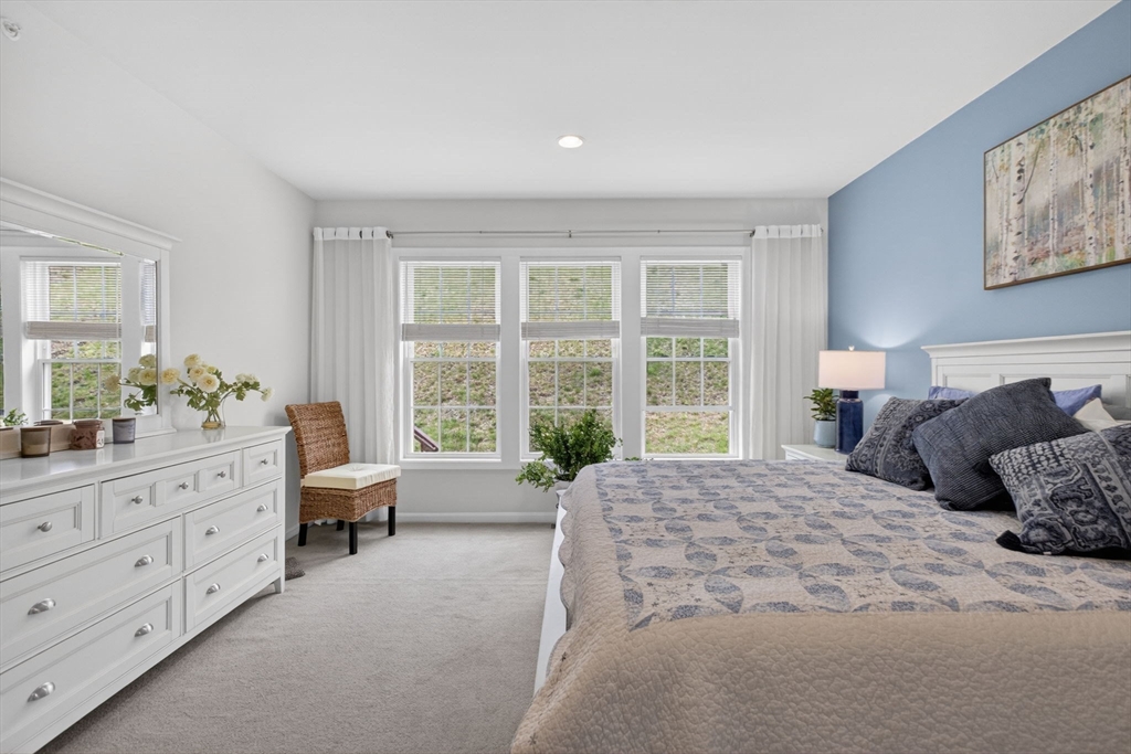 87 Shannon Way, Unit 86 Upton, MA 01568 - Photo 15 of 36 a spacious bedroom with a large bed and a window