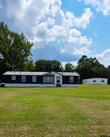 a view of a swimming pool with an outdoor seating and a garden
